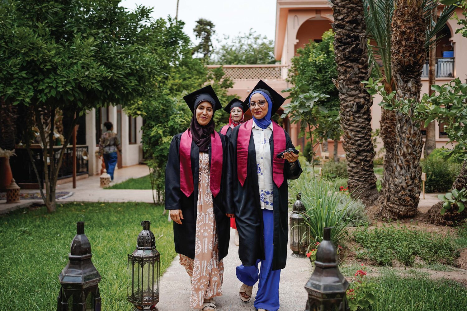 Two Amal graduates in cap and gown