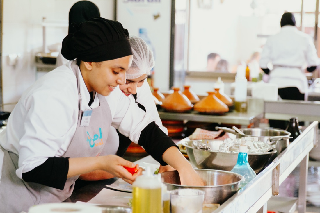 Amal trainees plating dishes in the Gueliz kitchen