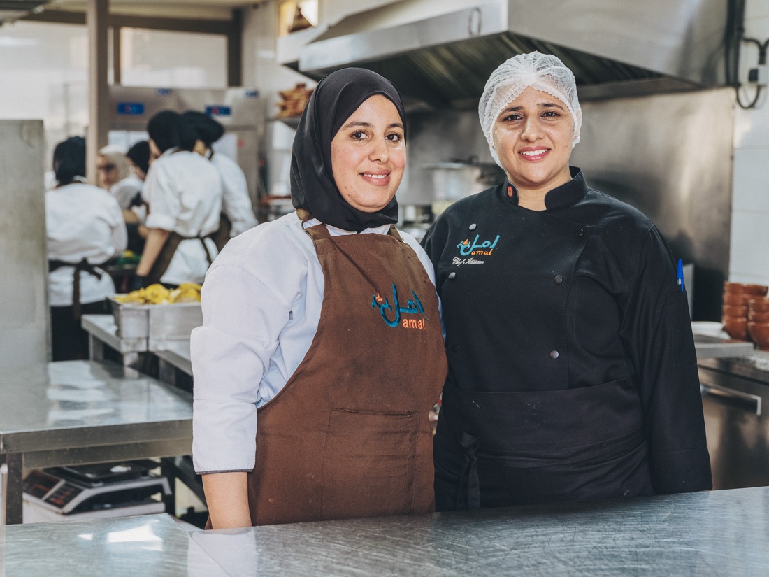 Two Amal chefs in the courtyard